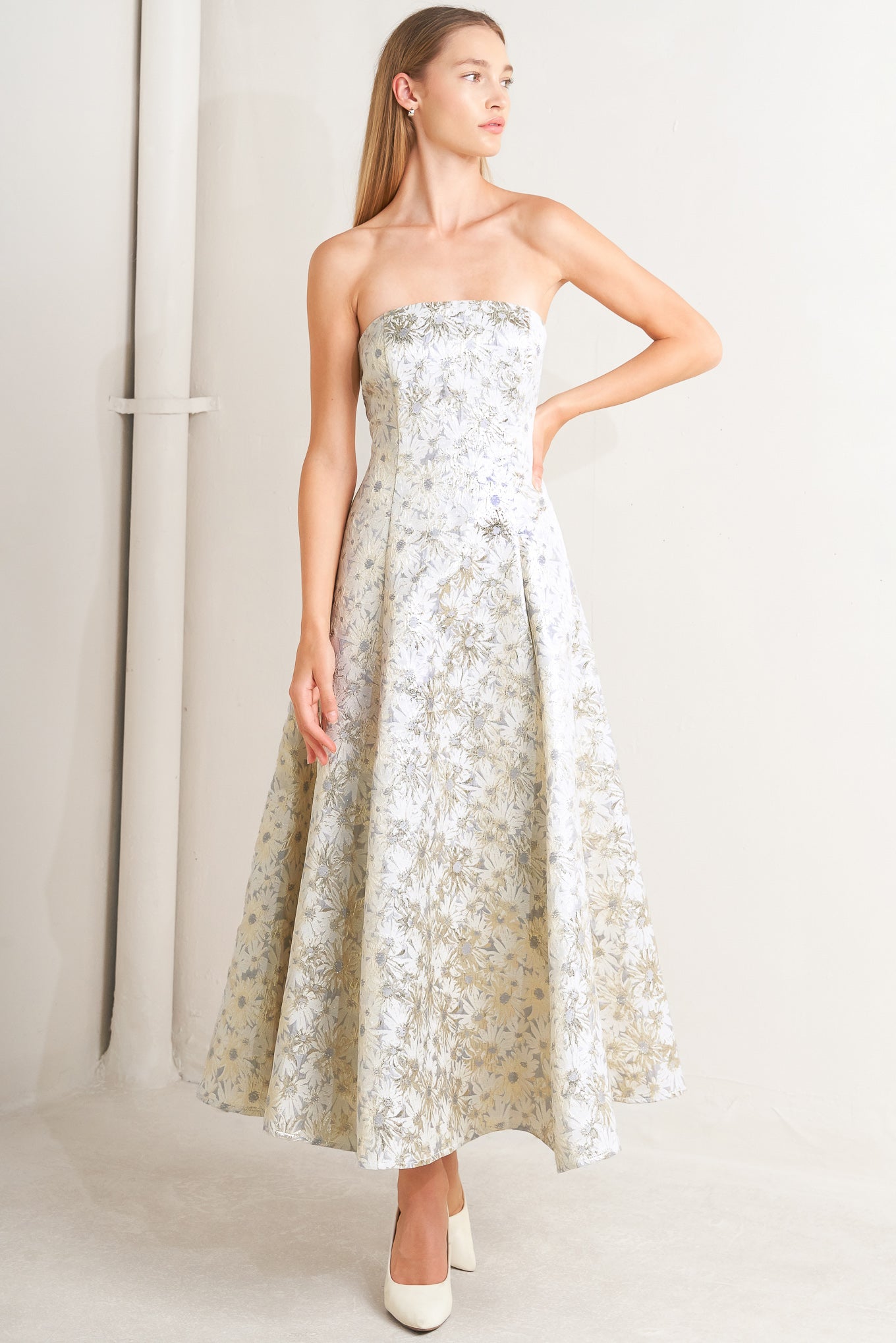 A woven jacquard woven midi dress featuring strapless neckline, circle skirt and smocked back with zipper closure