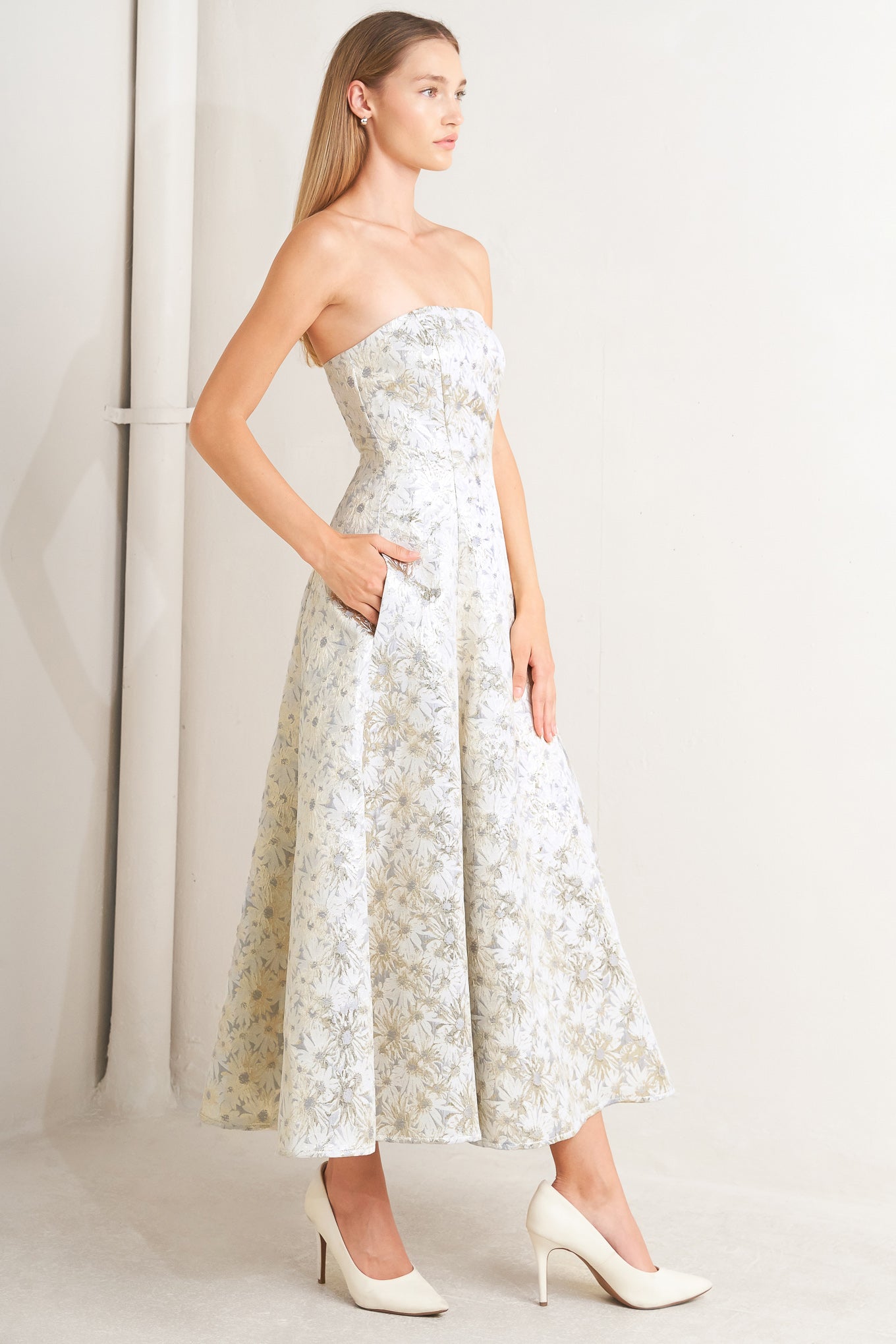 A woven jacquard woven midi dress featuring strapless neckline, circle skirt and smocked back with zipper closure