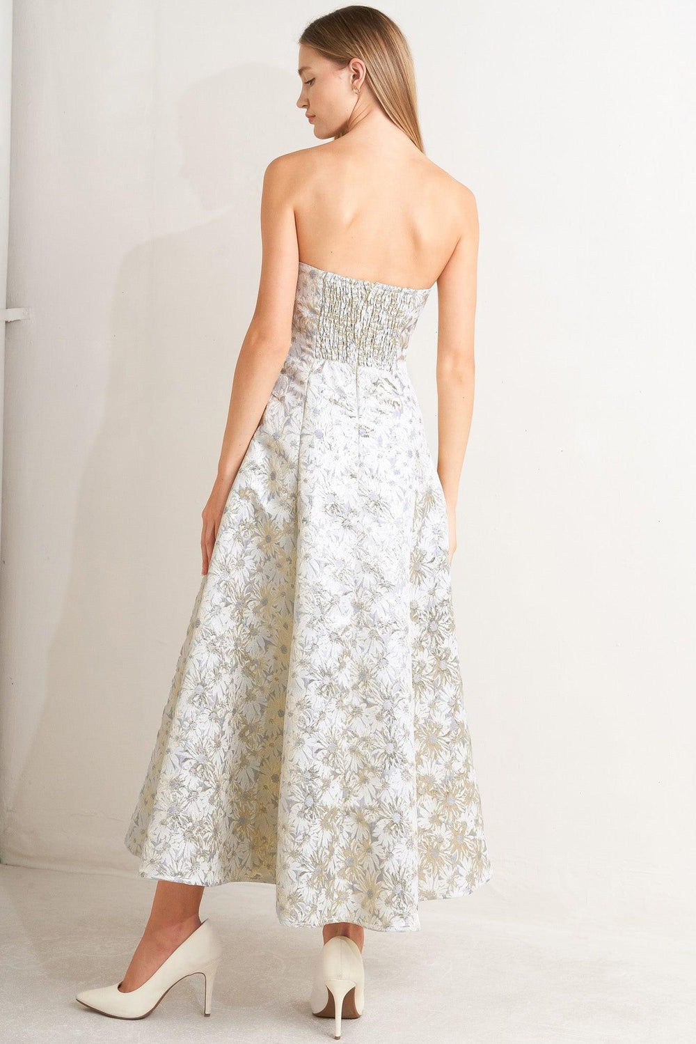 A woven jacquard woven midi dress featuring strapless neckline, circle skirt and smocked back with zipper closure