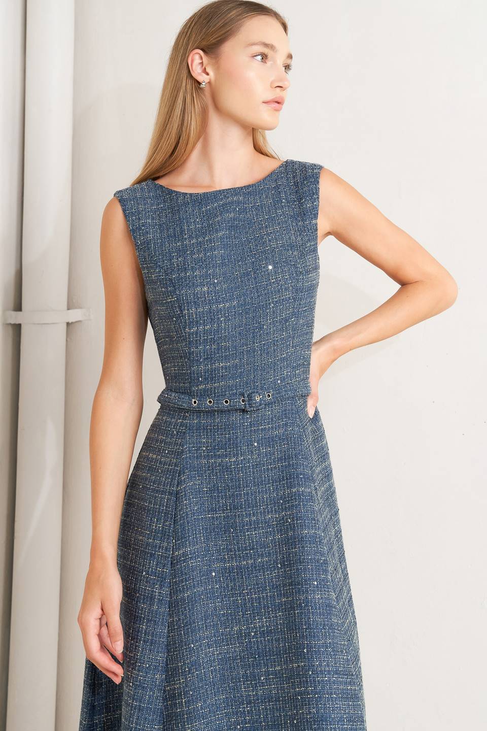 A woven tweed midi dress featuring round neckline, sleeveless, self belt, circle skirt and back zipper closure