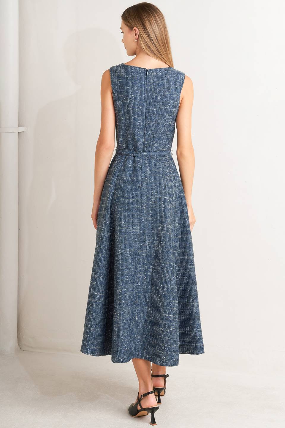 A woven tweed midi dress featuring round neckline, sleeveless, self belt, circle skirt and back zipper closure