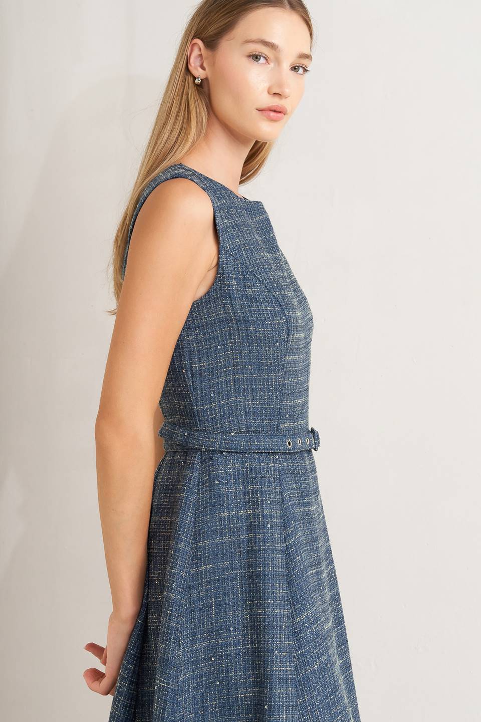A woven tweed midi dress featuring round neckline, sleeveless, self belt, circle skirt and back zipper closure