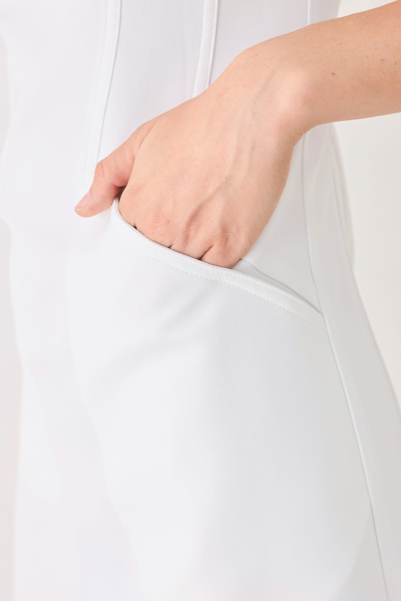 Woman wearing a white shift mini dress featuring wide round neckline, cap sleeve, pockets and back zipper closure | FREEMARKET