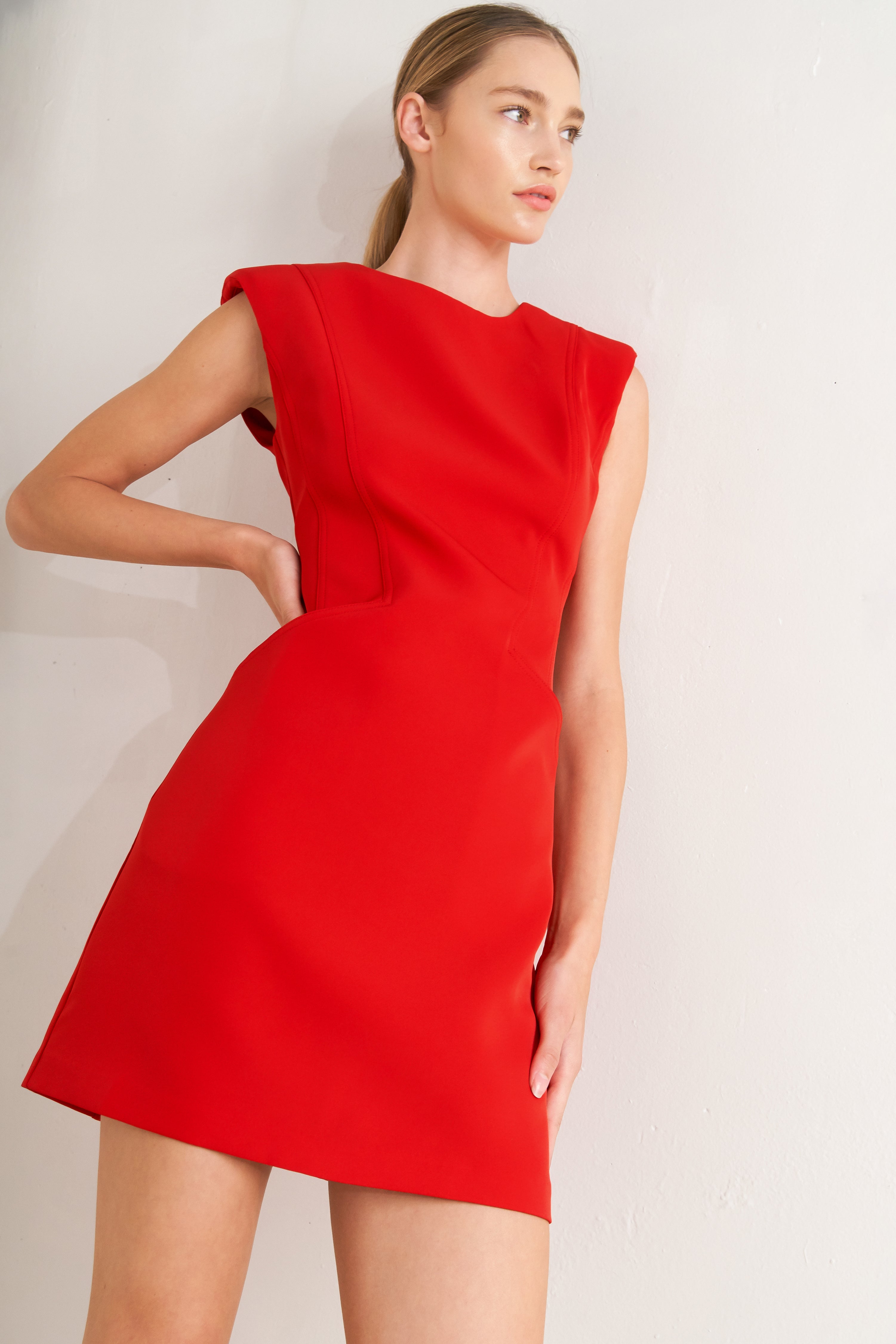 Woman wearing a red shift mini dress featuring wide round neckline, cap sleeve, pockets and back zipper closure | FREEMARKET