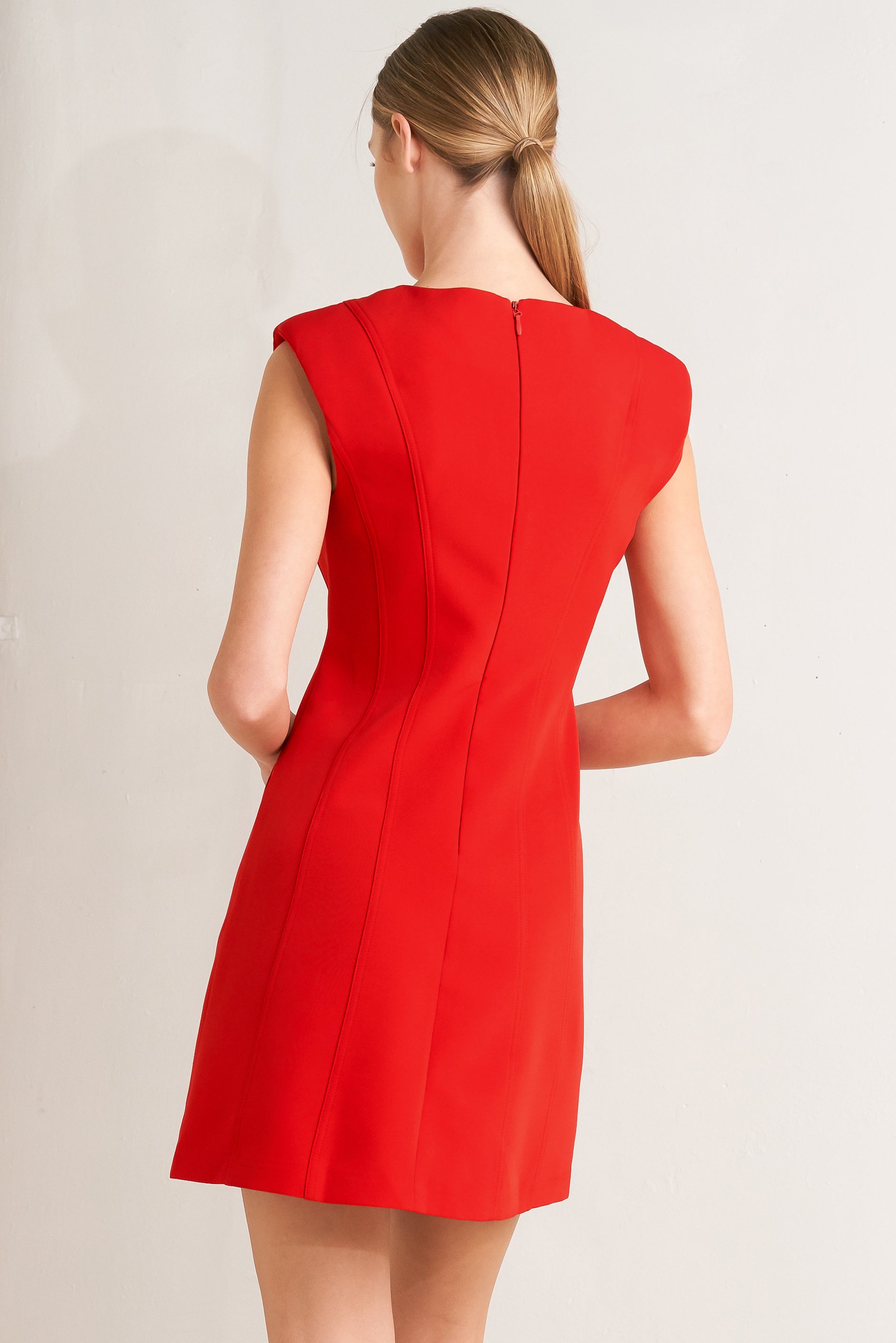 Woman wearing a red shift mini dress featuring wide round neckline, cap sleeve, pockets and back zipper closure | FREEMARKET