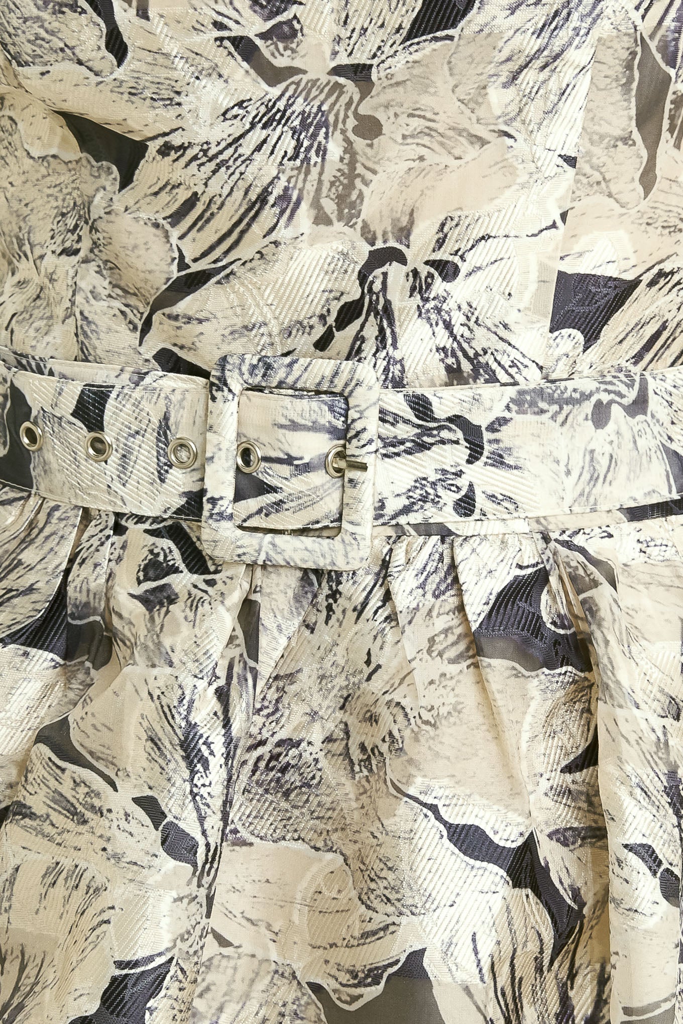 A textured woven midi dress featuring strapless, self belt, full skirt and back zipper closure