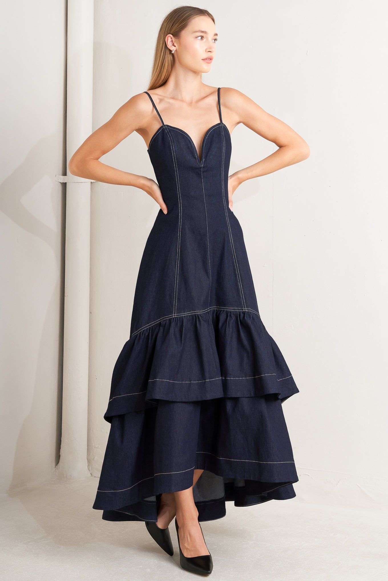 A denim midi dress featuring sweetheart neckline, straps, double layer ruffled bottom and back zipper closure