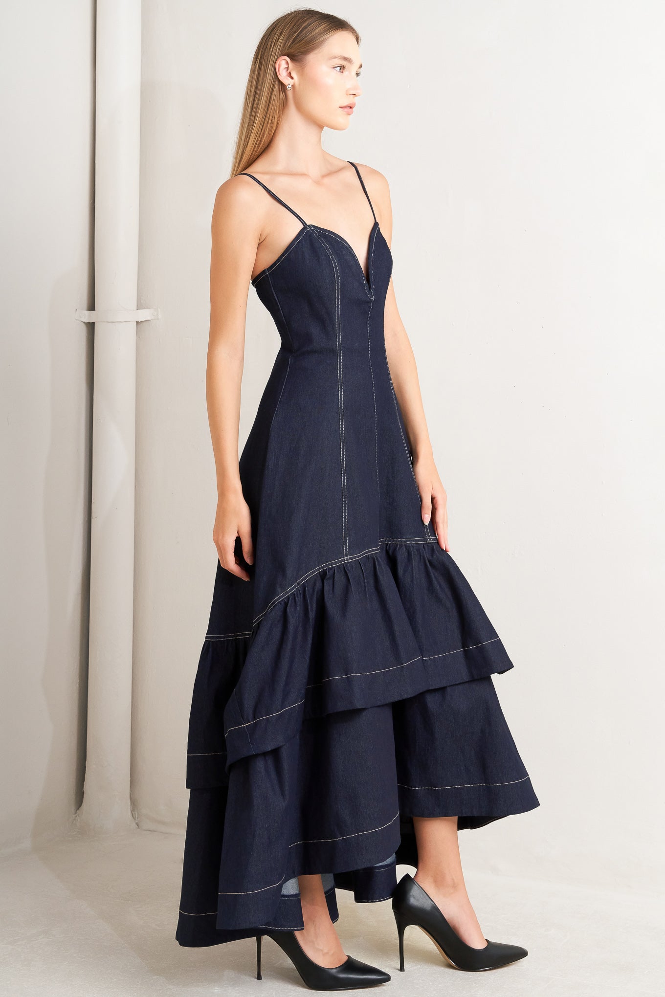A denim midi dress featuring sweetheart neckline, straps, double layer ruffled bottom and back zipper closure