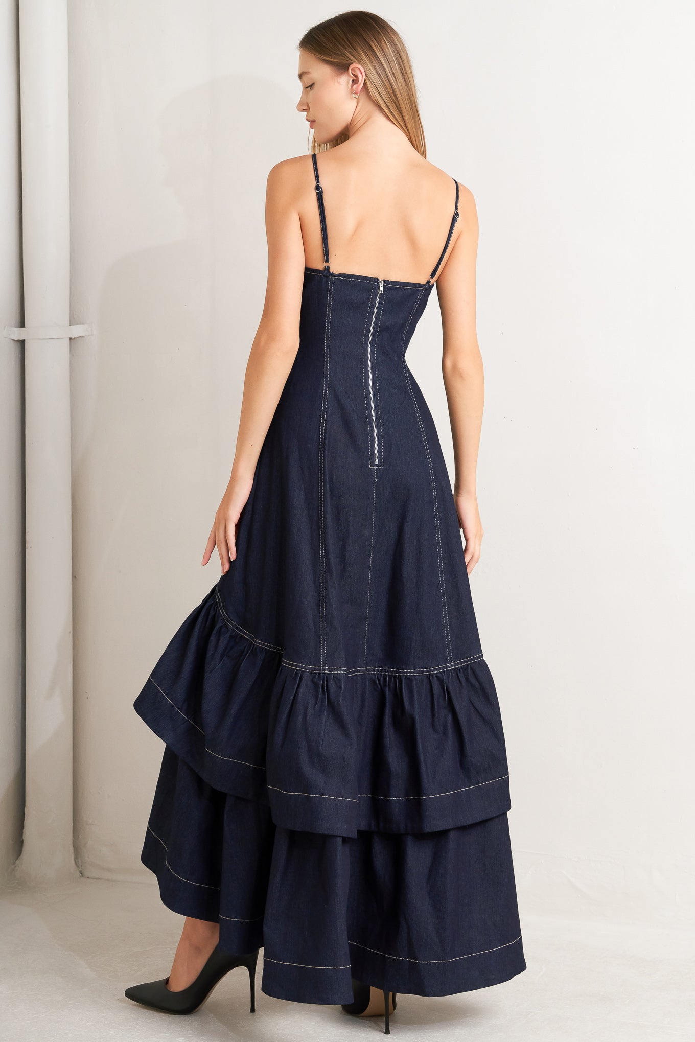 A denim midi dress featuring sweetheart neckline, straps, double layer ruffled bottom and back zipper closure