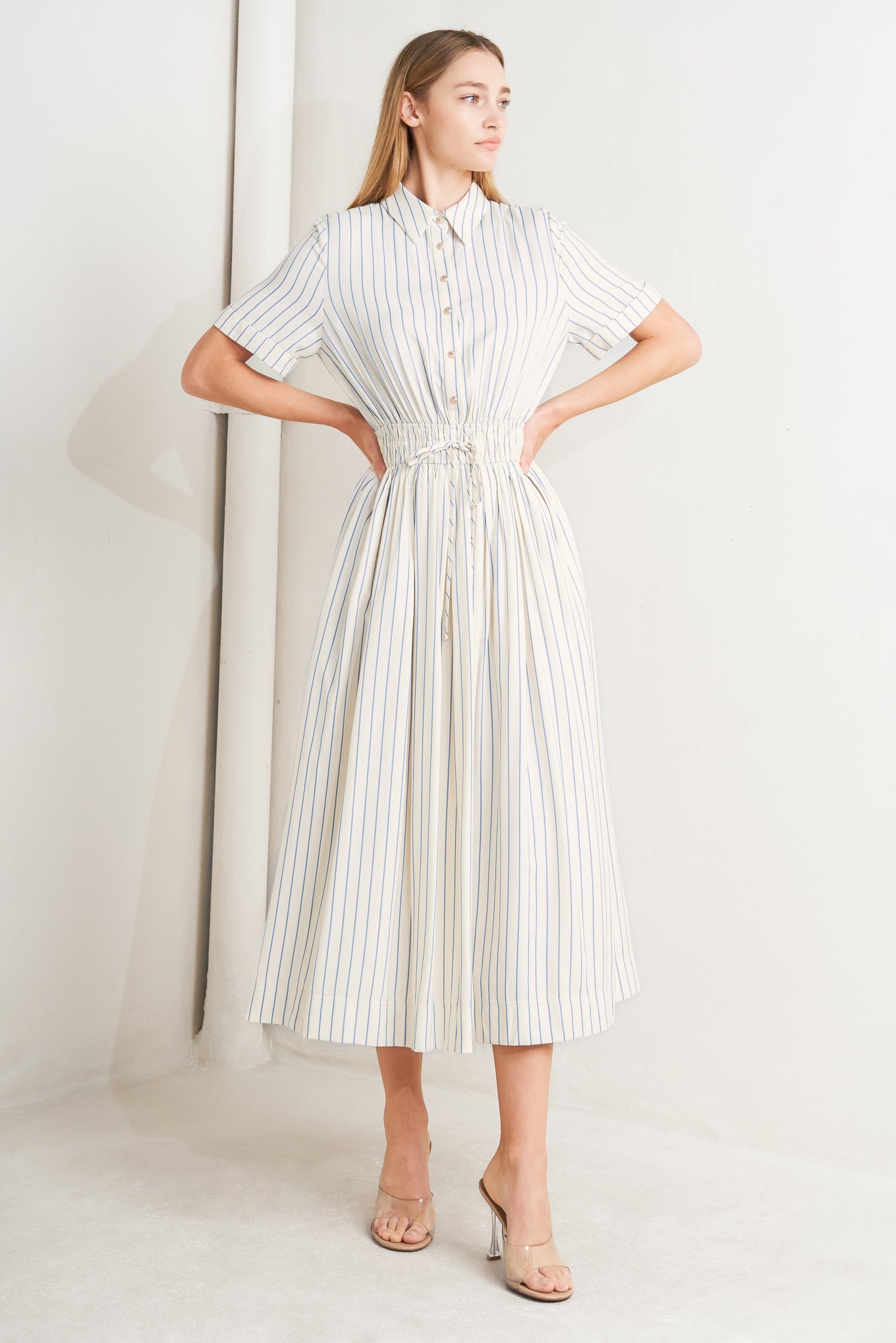 
A striped woven midi dress featuring collar, button down bodice, short sleeve, elasticized waist with tie and full skirt

Details:

Self : 65% Polyester 35% Cotton

Size &amp; Fit

- Model is 5`8" And Wearing Size Small
- Measurements Taken From Size Small
- Approx. Length: 51"