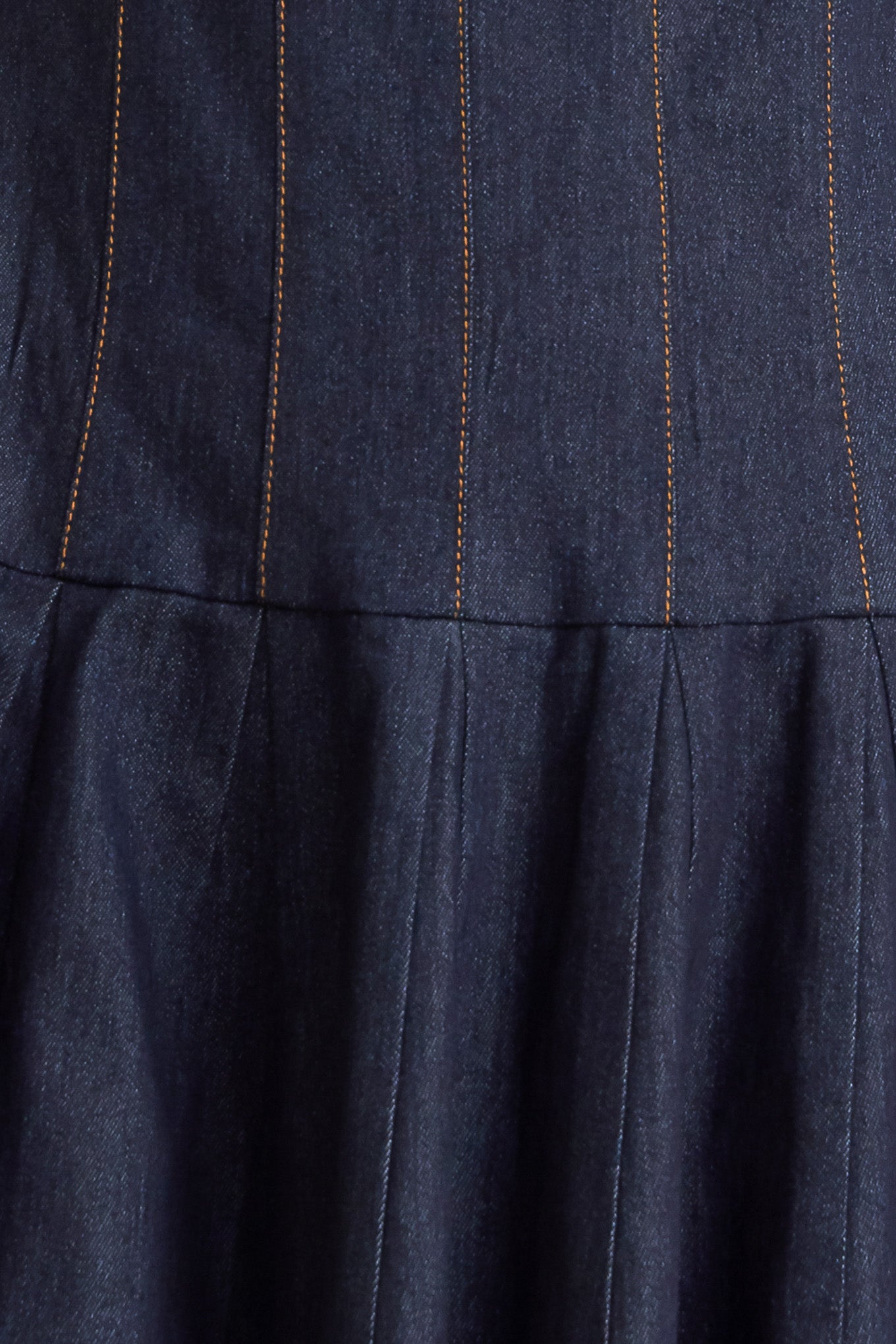 A denim midi dress featuring square neckline, sleeveless, dropped waistline, circle skirt and back zipper closure