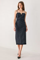 A woman modeling a sleeveless navy midi dress with thin white vertical rhinestone pinstripes, a sweetheart neckline, and a matching navy belt with silver-tone studs | FREEMARKET