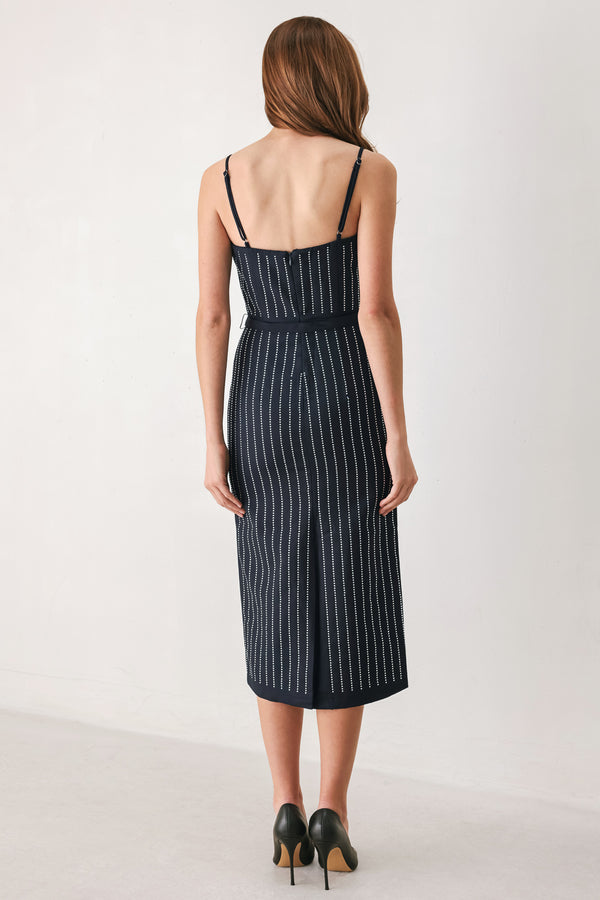 A woman modeling a sleeveless navy midi dress with thin white vertical rhinestone pinstripes, a sweetheart neckline, and a matching navy belt with silver-tone studs | FREEMARKET