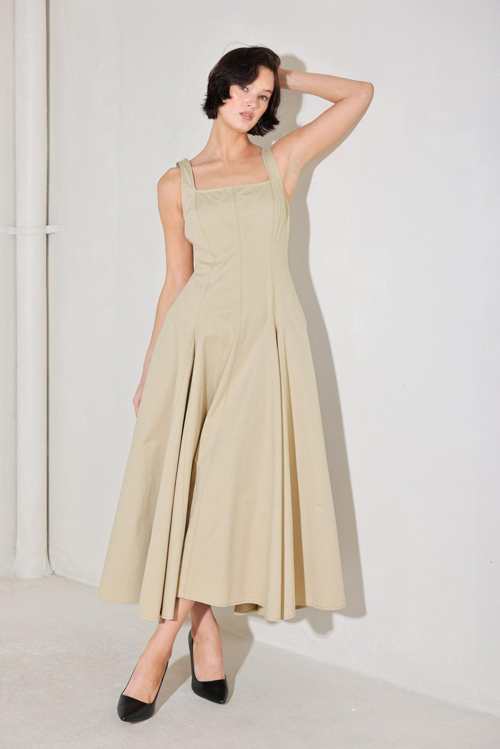 
A solid woven midi dress featuring square neckline, sleeveless, circle skirt and back zipper closure

Details:

Self : 100% Cotton

Size &amp; Fit

- Model is 5`8" And Wearing Size Small
- Measurements Taken From Size Small
- Approx. Length: 52"