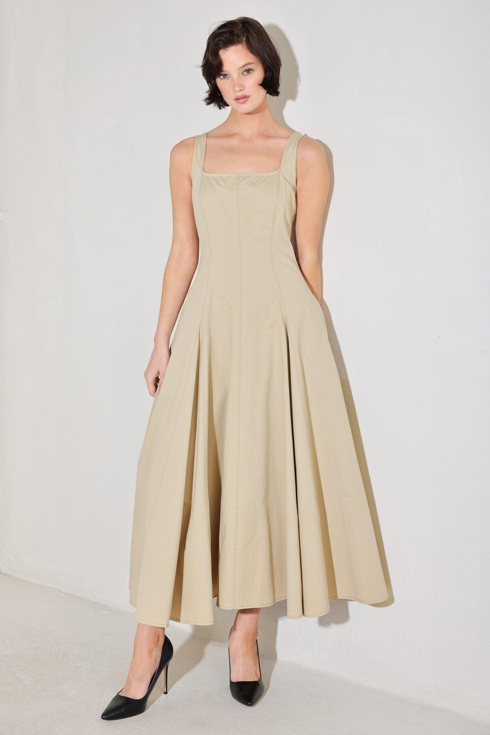 
A solid woven midi dress featuring square neckline, sleeveless, circle skirt and back zipper closure

Details:

Self : 100% Cotton

Size &amp; Fit

- Model is 5`8" And Wearing Size Small
- Measurements Taken From Size Small
- Approx. Length: 52"