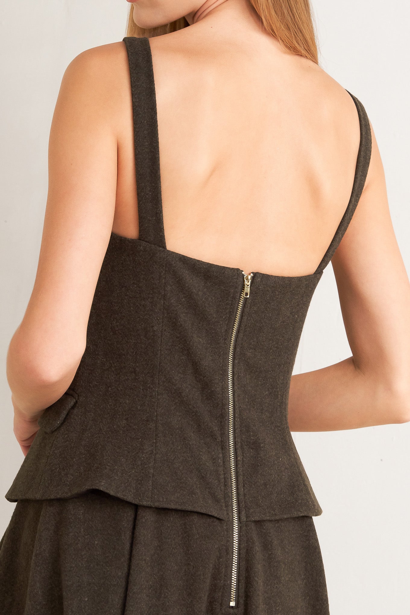 A solid woven midi dress featuring sweetheart neckline, straps, front button detail, circle skirt and back zipper closure