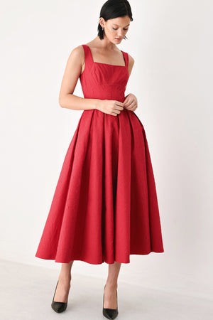 A woman modeling a sleeveless red midi dress with a square neckline, structured bodice, and full pleated skirt | FREEMARKET