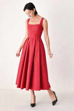 A woman modeling a sleeveless red midi dress with a square neckline, structured bodice, and full pleated skirt | FREEMARKET