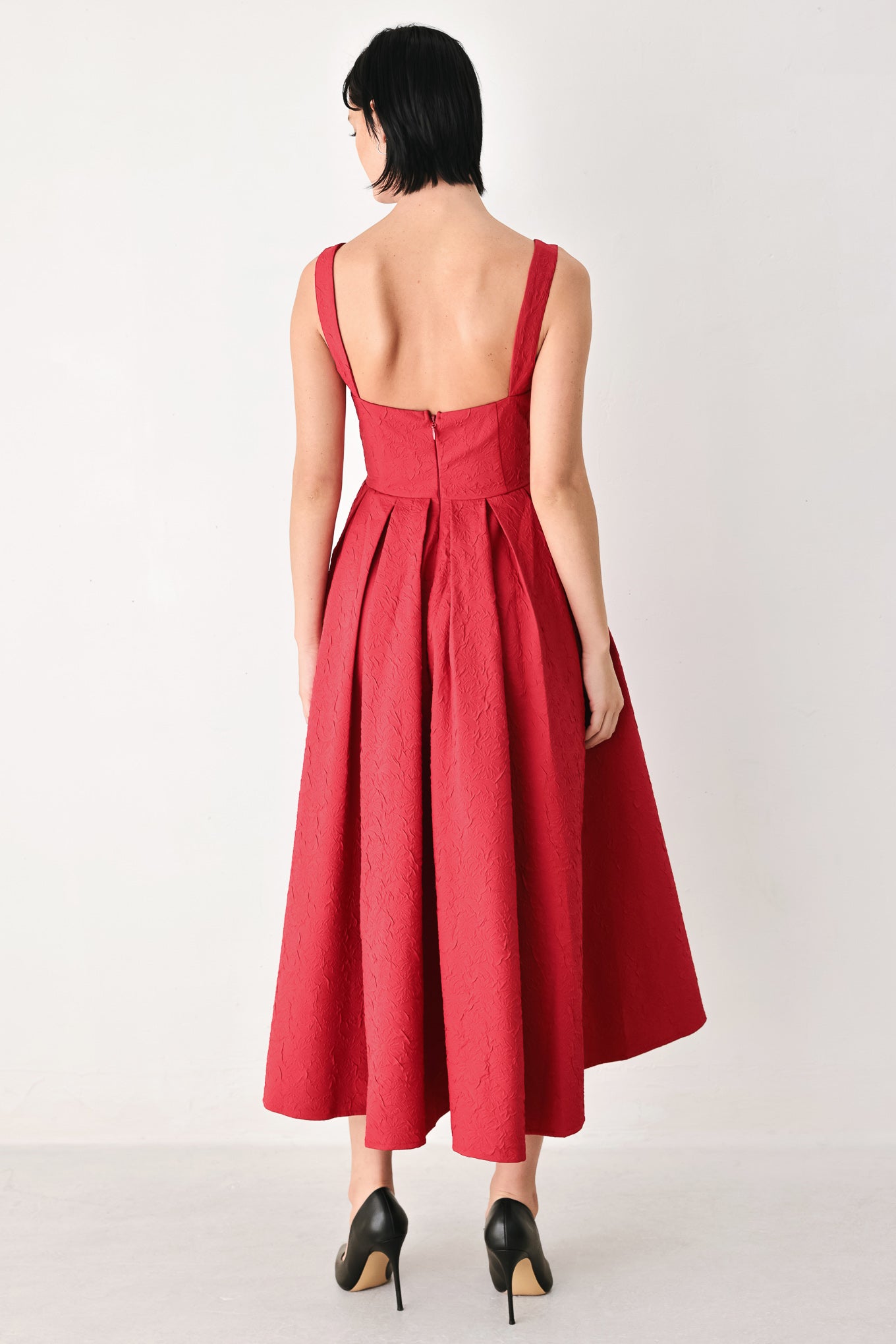 A woman modeling a sleeveless red midi dress with a square neckline, structured bodice, and full pleated skirt | FREEMARKET