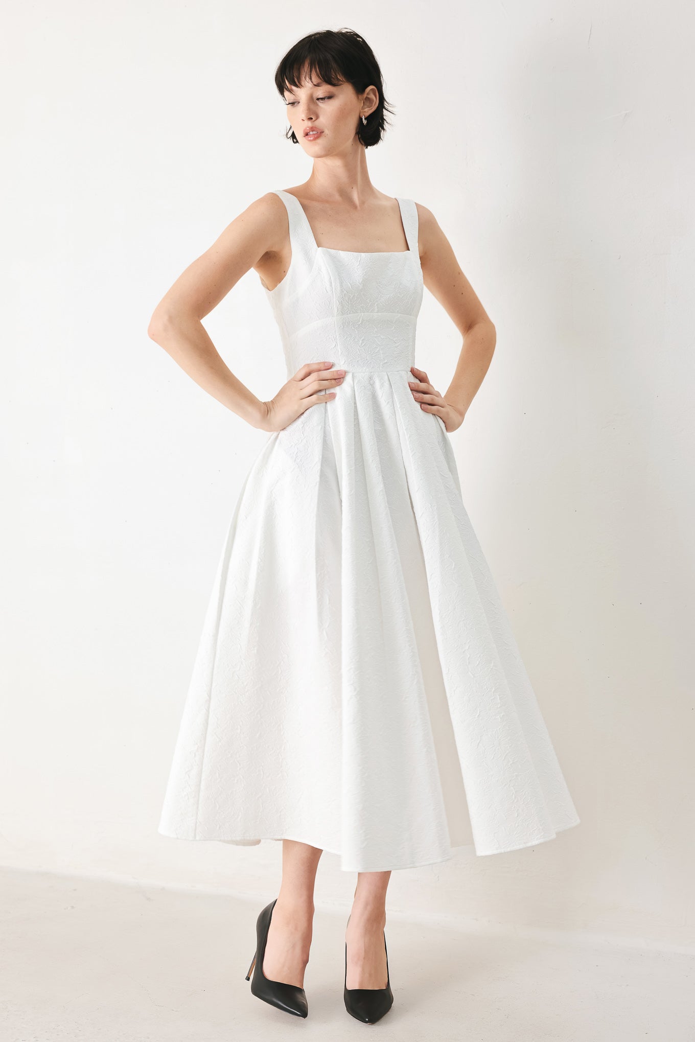 Woman wearing a white midi dress featuring straight neckline, straps, full skirt and back zipper closure | FREEMARKET