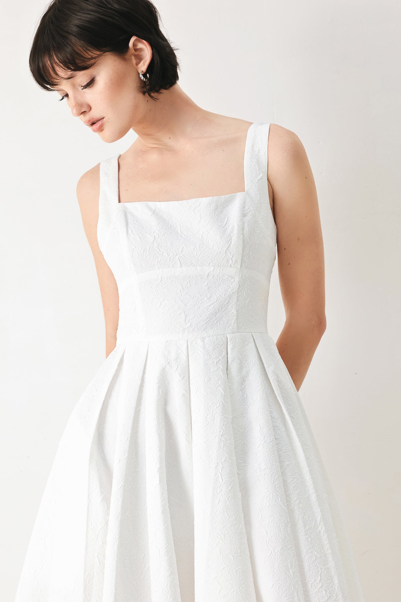 Woman wearing a white midi dress featuring straight neckline, straps, full skirt and back zipper closure | FREEMARKET