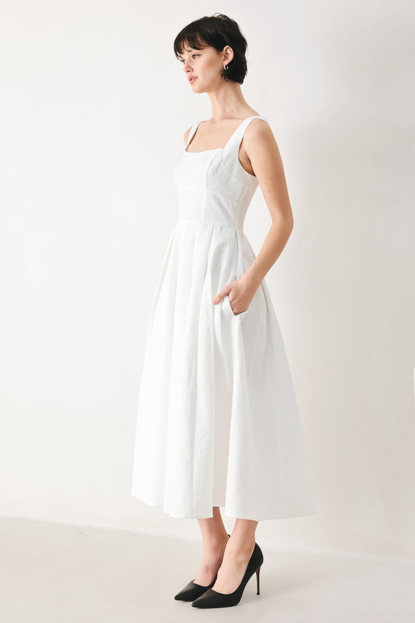 Woman wearing a white midi dress featuring straight neckline, straps, full skirt and back zipper closure | FREEMARKET
