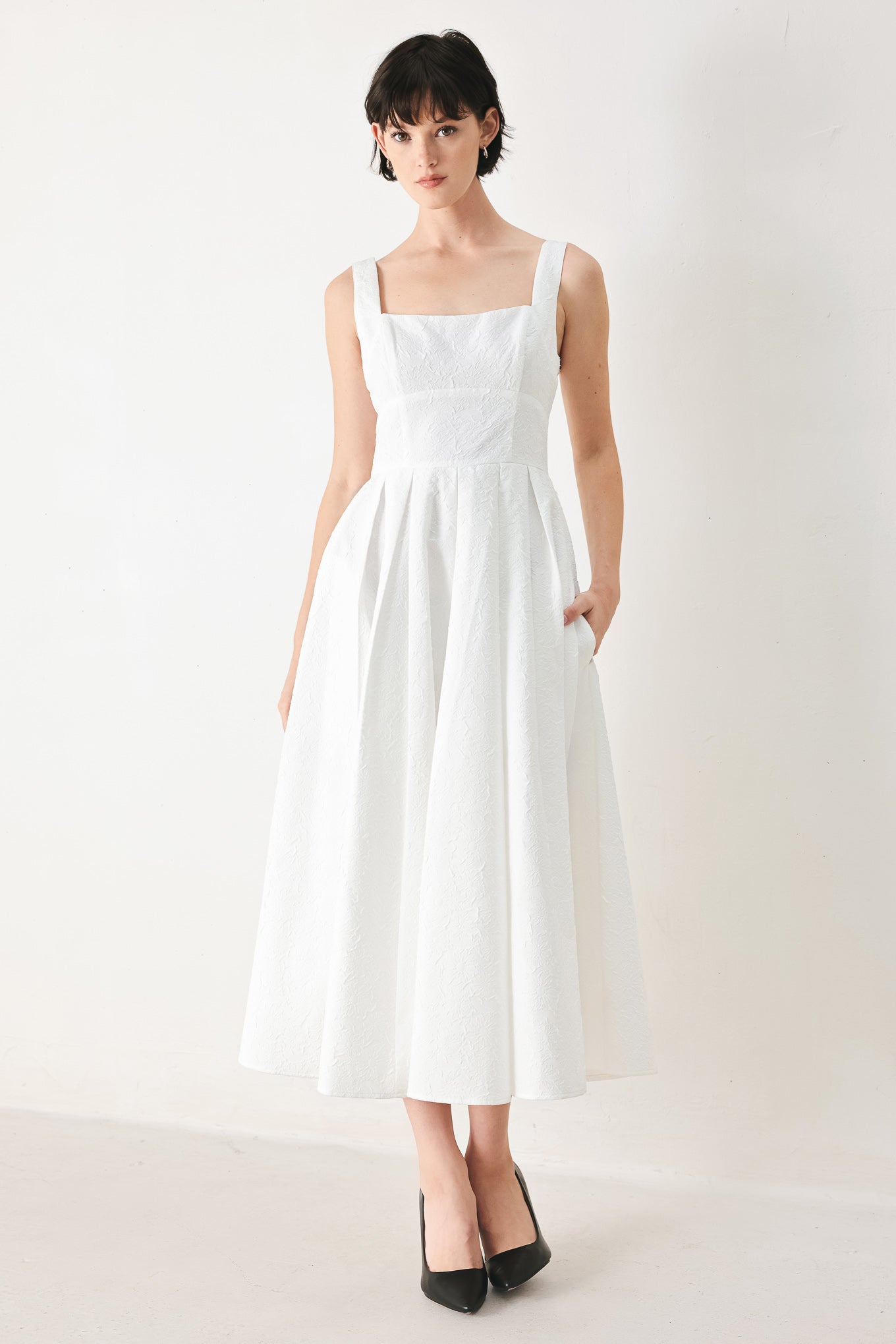 Woman wearing a white midi dress featuring straight neckline, straps, full skirt and back zipper closure | FREEMARKET