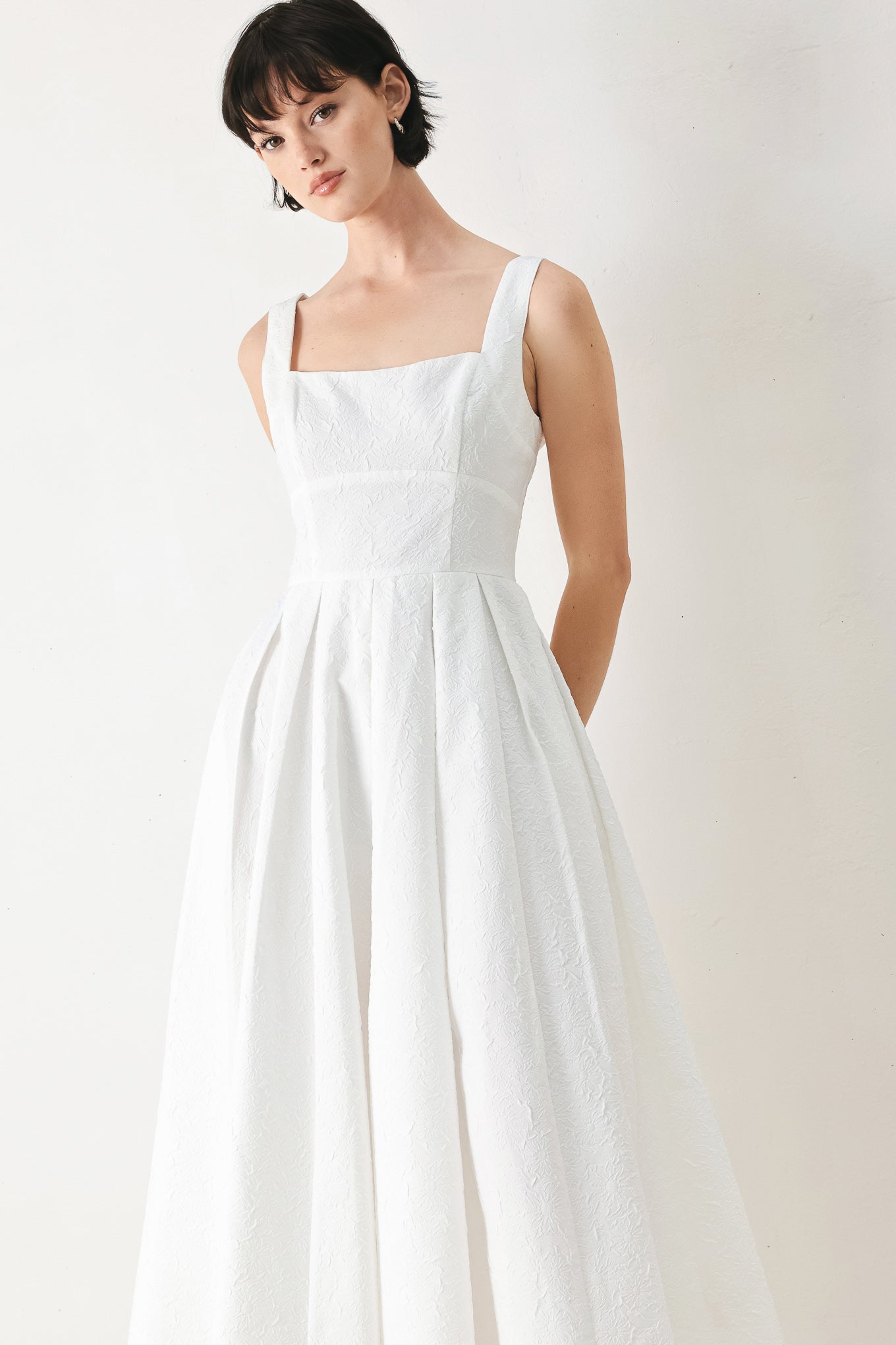 Woman wearing a white midi dress featuring straight neckline, straps, full skirt and back zipper closure | FREEMARKET