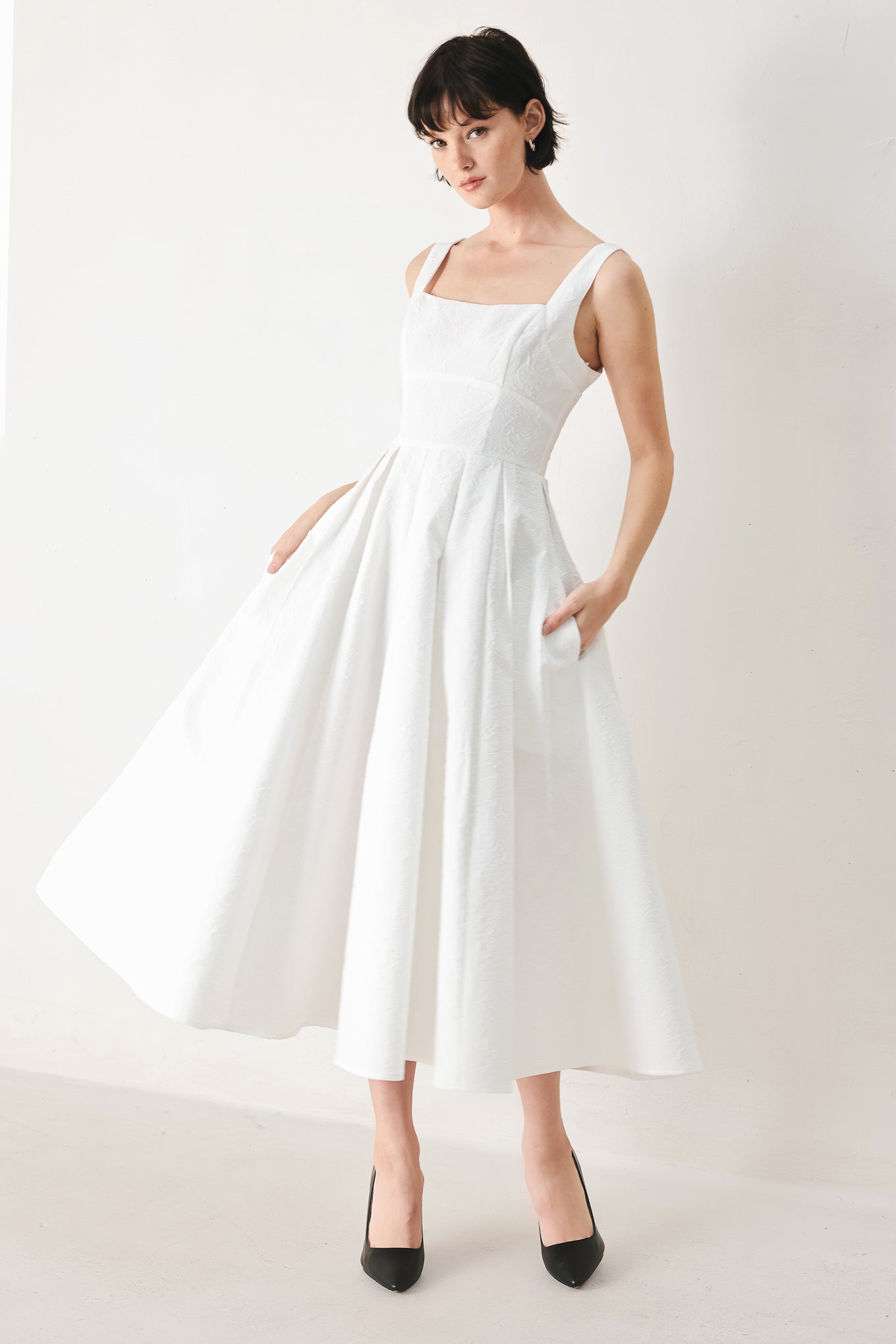 Woman wearing a white midi dress featuring straight neckline, straps, full skirt and back zipper closure | FREEMARKET