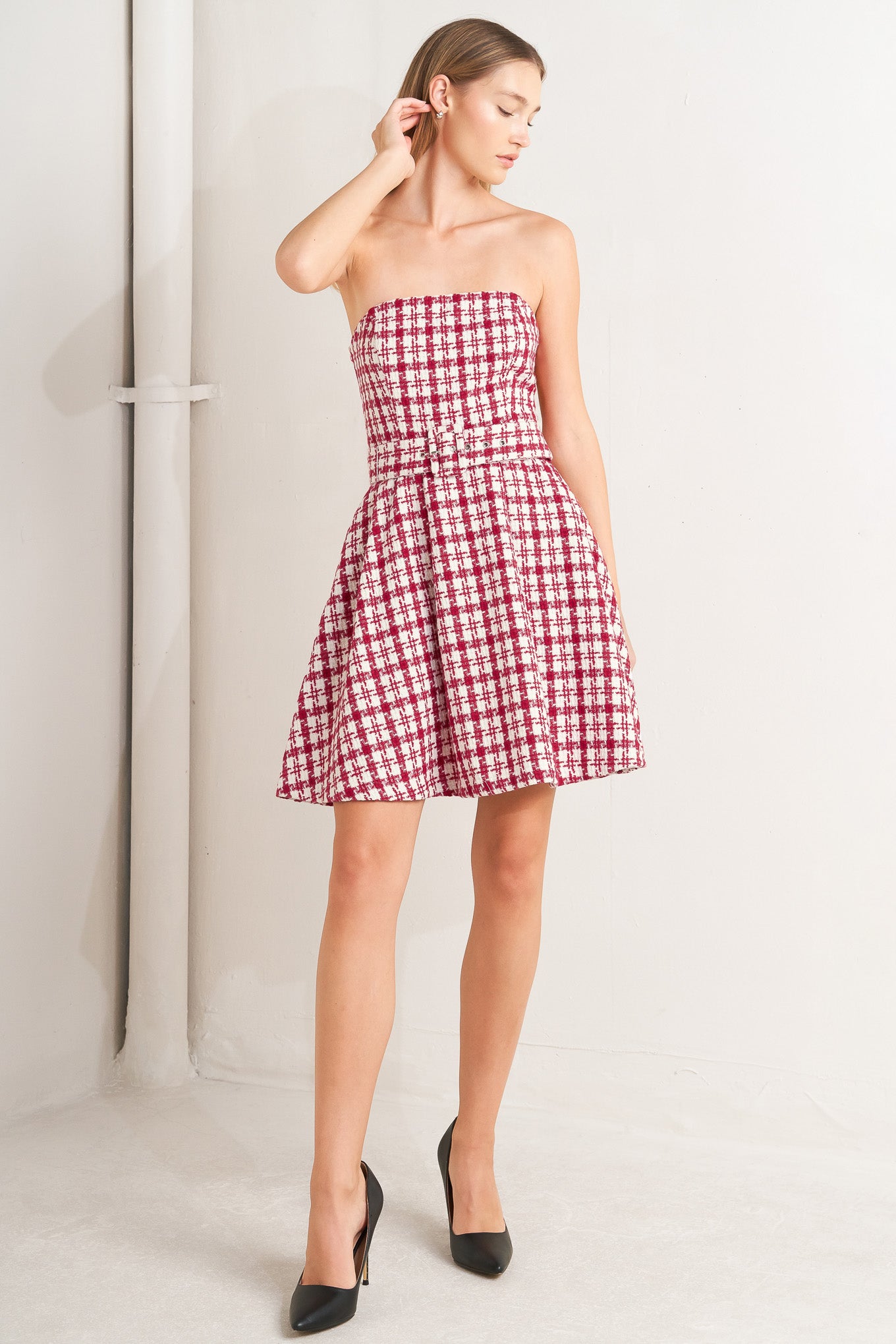 A tweed mini dress featuring strapless, self belt, circle skirt and back zipper closure