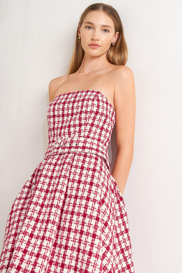 A tweed mini dress featuring strapless, self belt, circle skirt and back zipper closure