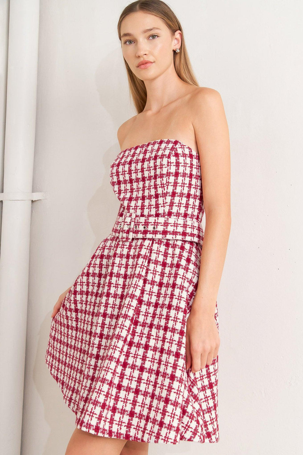 A tweed mini dress featuring strapless, self belt, circle skirt and back zipper closure