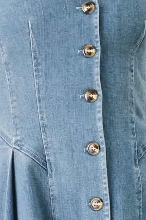 Woman wearing a sleeveless blue denim midi dress with V neckline, button down, and side pleat | FREEMARKET