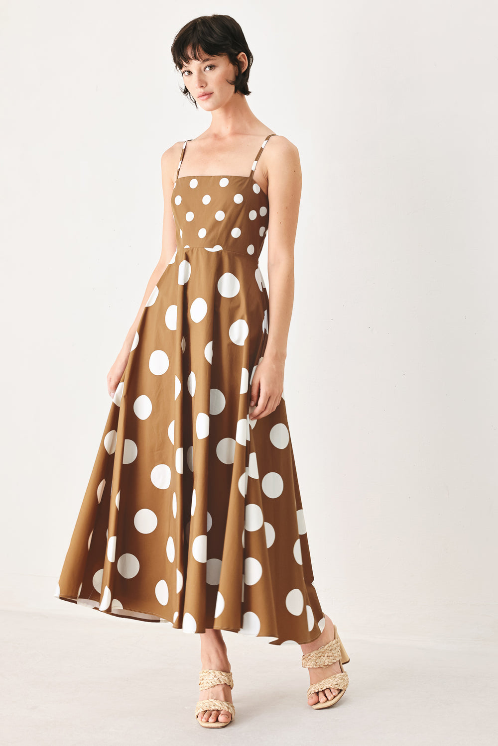 A printed woven midi dress featuring straight neckline, straps, circle skirt and back zipper closure
