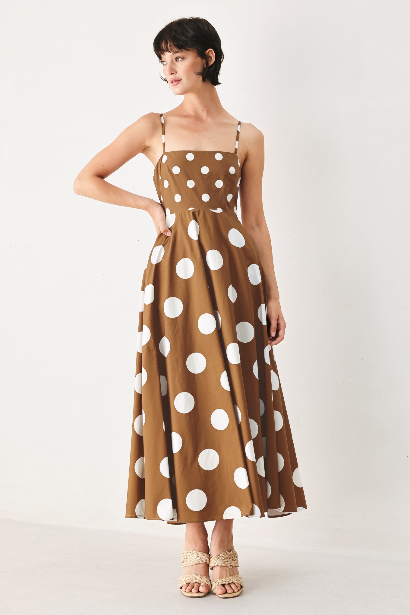 A printed woven midi dress featuring straight neckline, straps, circle skirt and back zipper closure