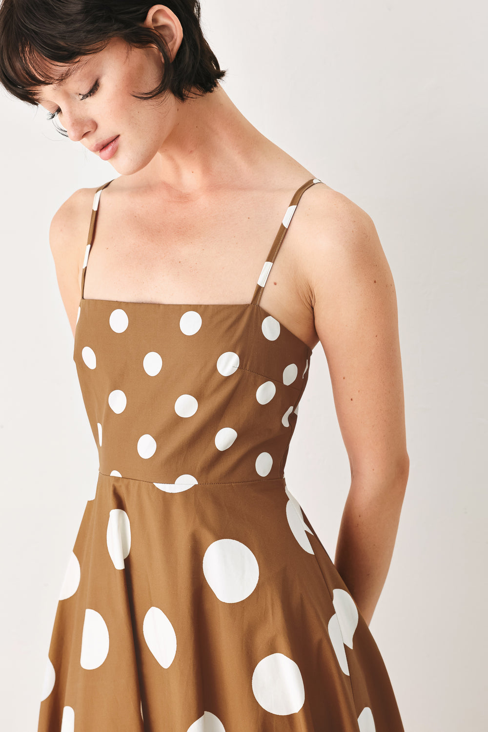 A printed woven midi dress featuring straight neckline, straps, circle skirt and back zipper closure