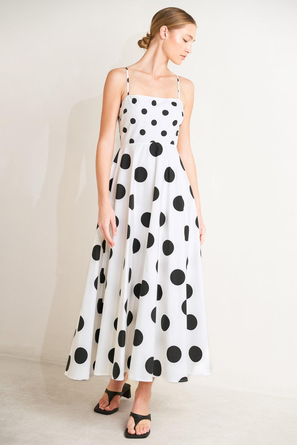 A printed woven midi dress featuring straight neckline, straps, circle skirt and back zipper closure