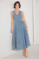 
A washed denim midi dress featuring V neckline, sleeveless, self belt, circle skirt, side pockets and back zipper closure

Details:

Self : 90% Cotton 10% Polyester

Size &amp; Fit

- Model is 5`8" And Wearing Size Small
- Measurements Taken From Size Small
- Approx. Length: 50"