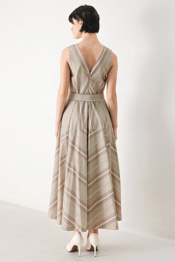 Woman wearing a striped sleeveless woven midi dress featuring V neckline, drop waist, self tie, circle skirt and back zipper closure | FREEMARKET
