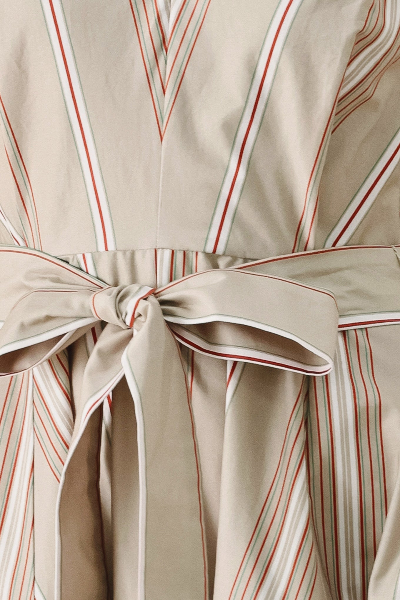 Close up of a striped sleeveless woven midi dress featuring V neckline, drop waist, self tie, circle skirt and back zipper closure | FREEMARKET