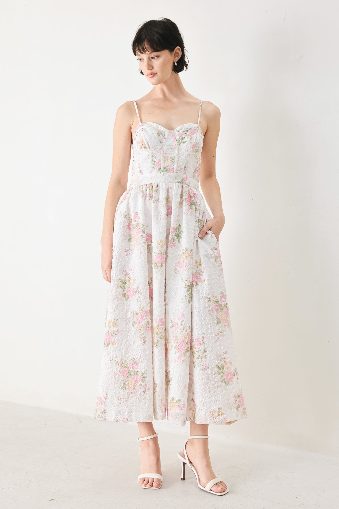 Woman wearing a floral midi dress featuring bustier top, straps, full skirt and back zipper closure | FREEMARKET