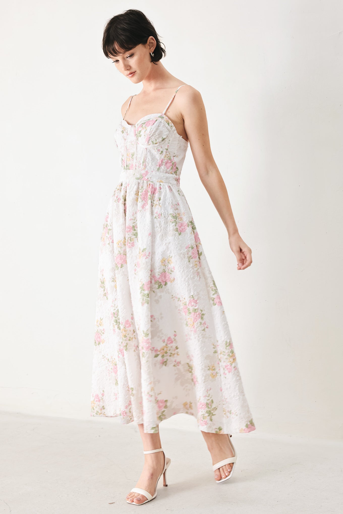 Woman wearing a floral midi dress featuring bustier top, straps, full skirt and back zipper closure | FREEMARKET