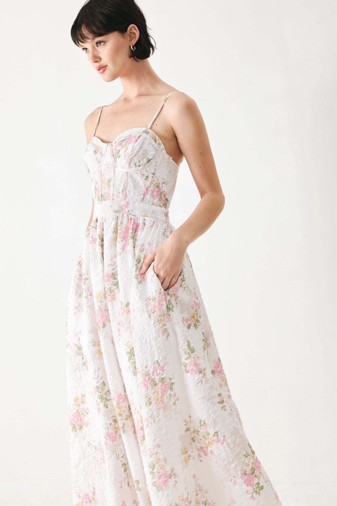 Woman wearing a floral midi dress featuring bustier top, straps, full skirt and back zipper closure | FREEMARKET