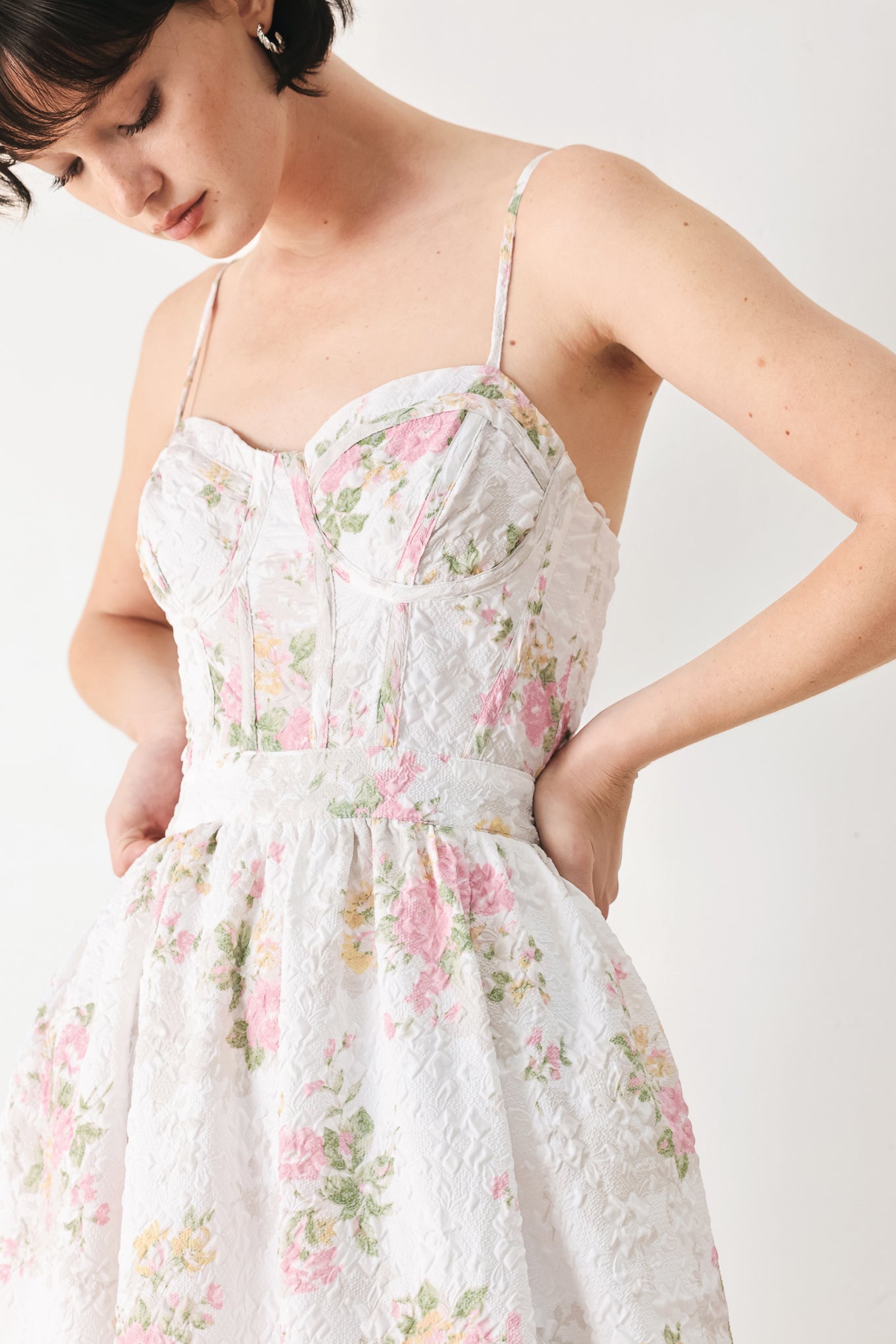 Woman wearing a floral midi dress featuring bustier top, straps, full skirt and back zipper closure | FREEMARKET
