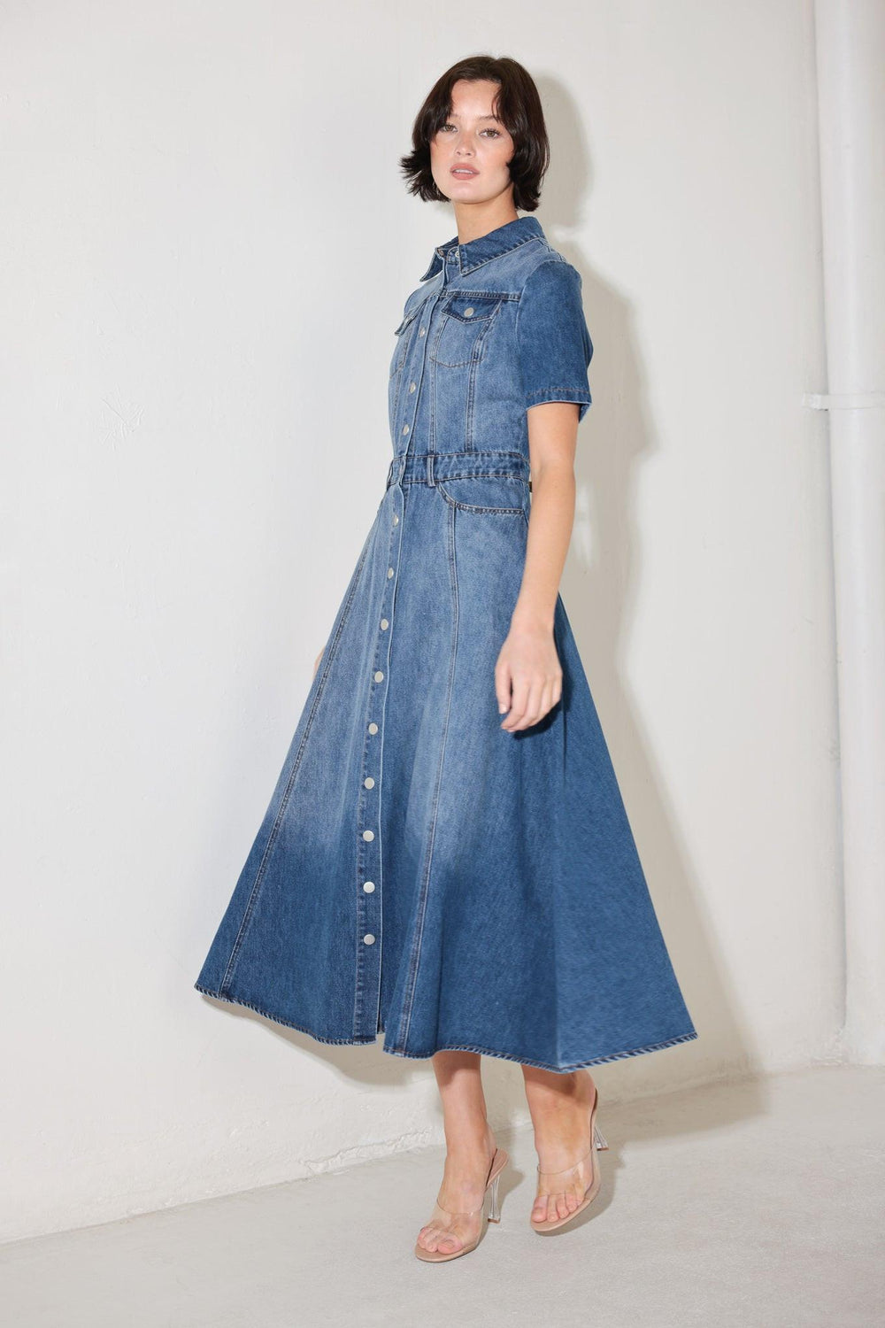 
A washed denim midi dress featuring, collar, short sleeve, pockets, front button down and circle skirt

Details:

Self : 90% Cotton 10% Polyester

Size &amp; Fit

- Model is 5`8" And Wearing Size Small
- Measurements Taken From Size Small
- Approx. Length: 50"