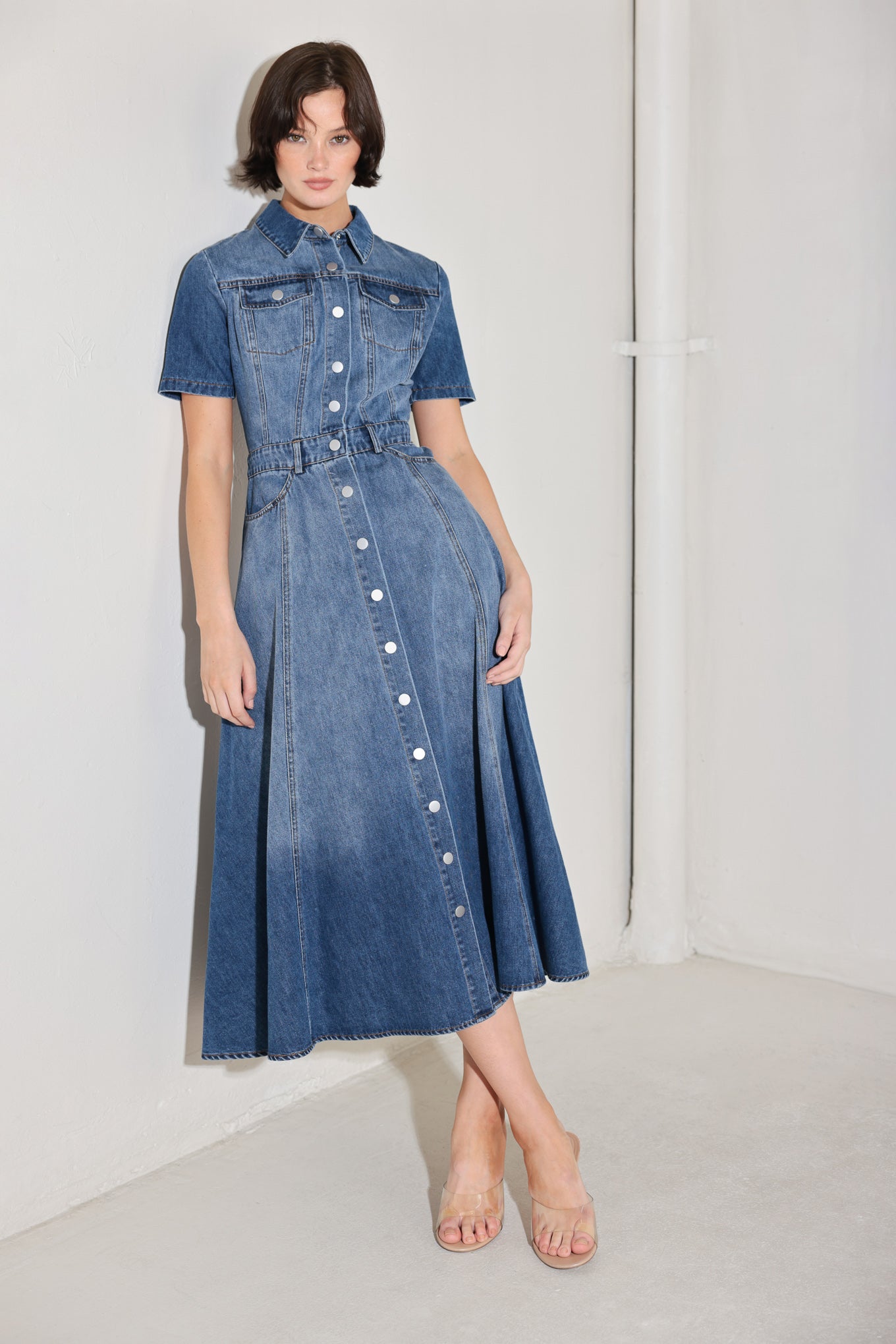 
A washed denim midi dress featuring, collar, short sleeve, pockets, front button down and circle skirt

Details:

Self : 90% Cotton 10% Polyester

Size &amp; Fit

- Model is 5`8" And Wearing Size Small
- Measurements Taken From Size Small
- Approx. Length: 50"