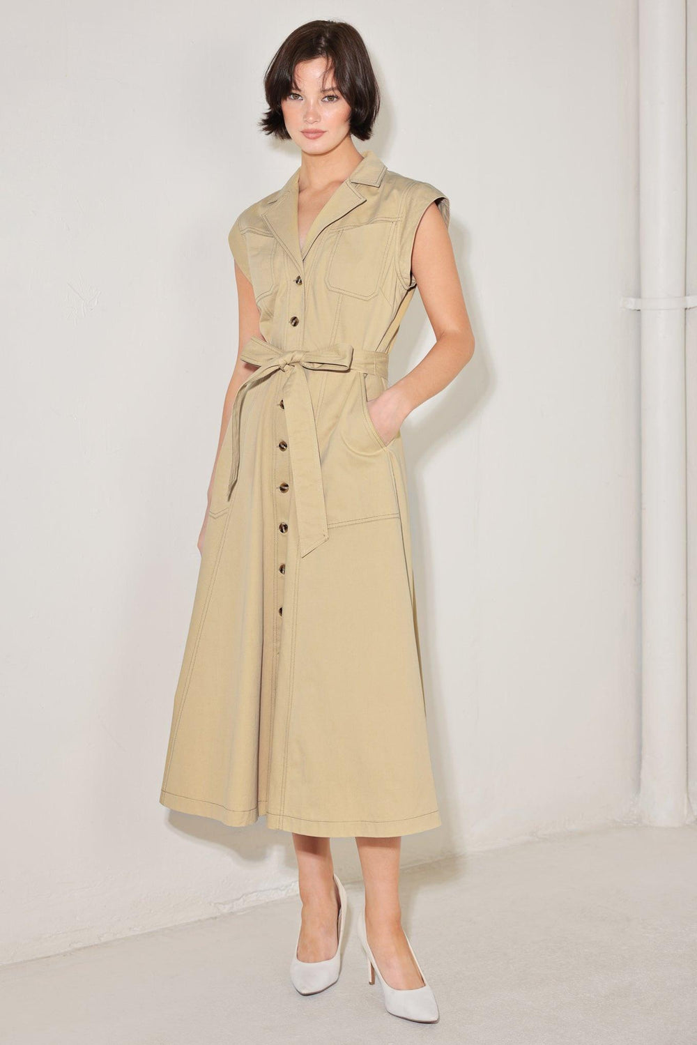 
A solid woven midi dress featuring collar, cap sleeve, pockets, button down, self sash tie and circle skirt

Details:

Self : 100% Cotton

Size &amp; Fit

- Model is 5`8" And Wearing Size Small
- Measurements Taken From Size Small
- Approx. Length: 49"