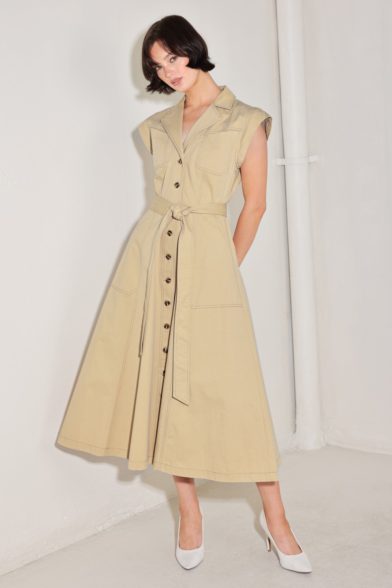 
A solid woven midi dress featuring collar, cap sleeve, pockets, button down, self sash tie and circle skirt

Details:

Self : 100% Cotton

Size &amp; Fit

- Model is 5`8" And Wearing Size Small
- Measurements Taken From Size Small
- Approx. Length: 49"