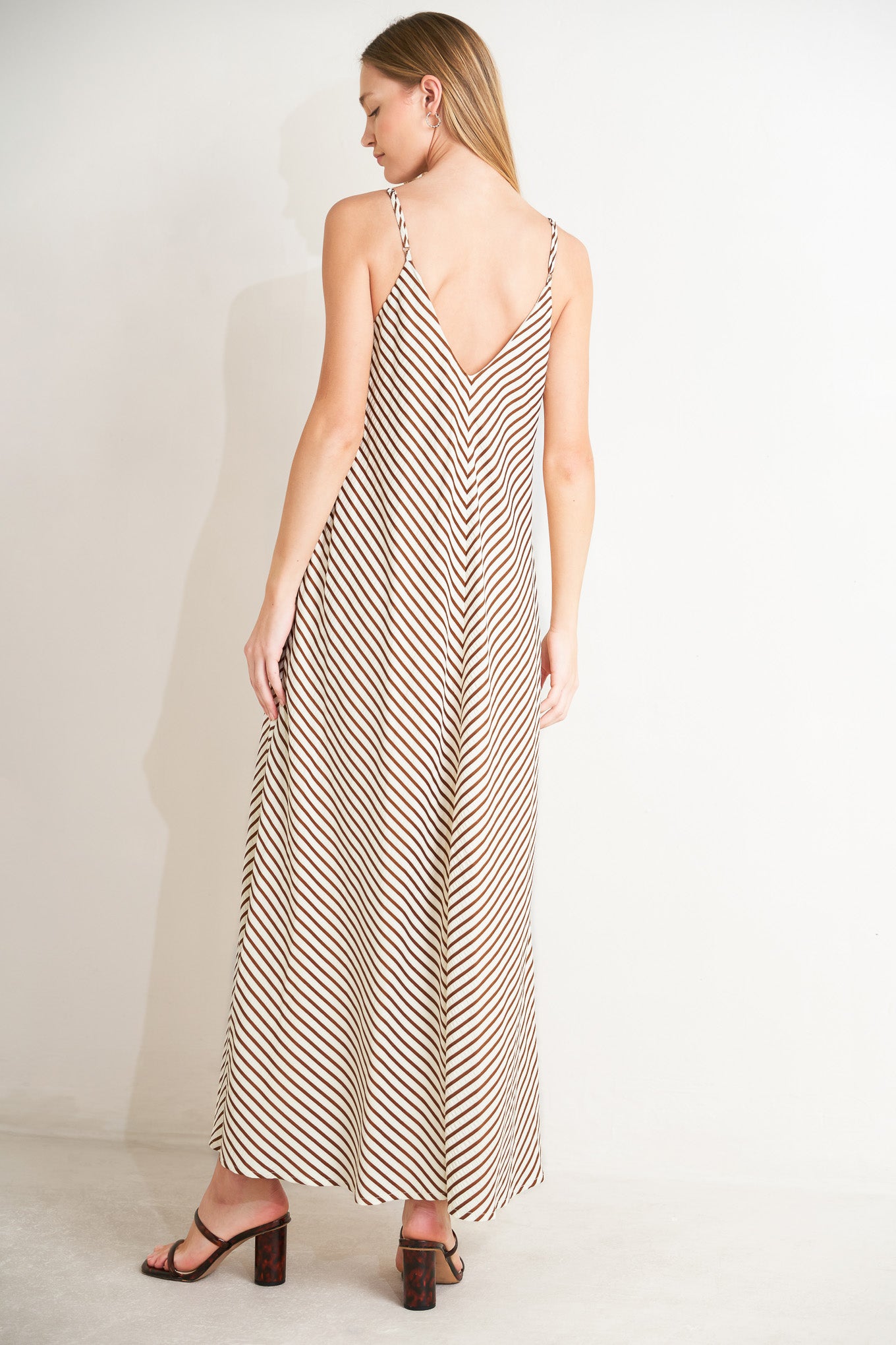 
A striped woven midi dress with V neckline and straps

Details:

Self : 97% Polyester 3% Spandex
Lining : 100% Polyester

Size &amp; Fit

- Model is 5`8" And Wearing Size Small
- Measurements Taken From Size Small
- Approx. Length: 55"