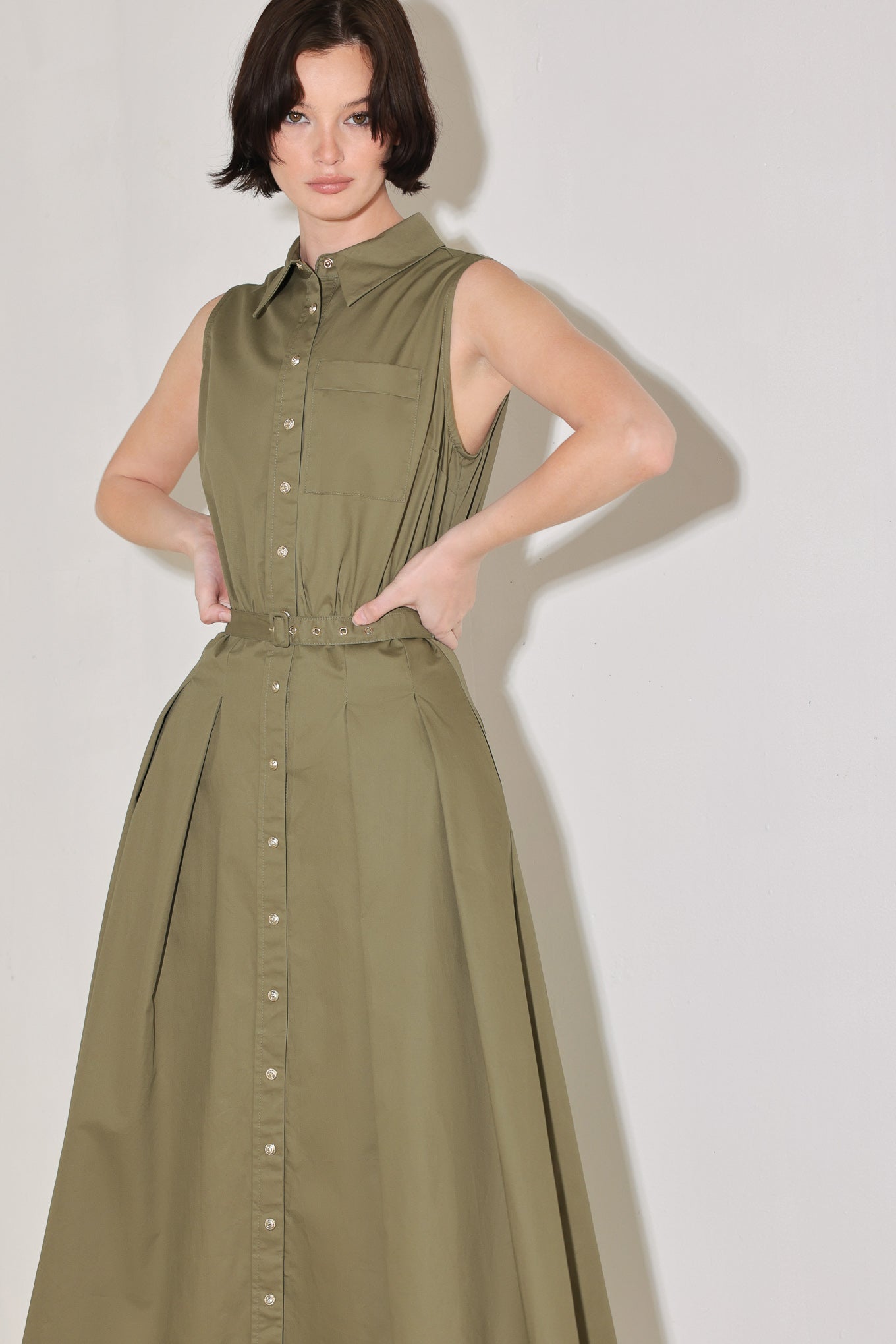 
A solid woven midi dress featuring collar, sleeveless, front button down, self belt and full circle skirt

Details:

Self : 100% Cotton

Size &amp; Fit

- Model is 5`8" And Wearing Size Small
- Measurements Taken From Size Small
- Approx. Length: 52"